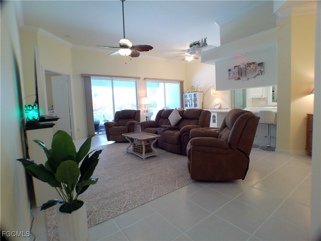 4780 Martinique Way Naples, FL 34119 - Photo 22 of 49 a living room with furniture and a chandelier