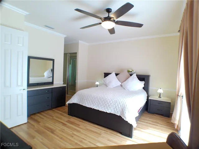 a bedroom with a bed and a potted plant