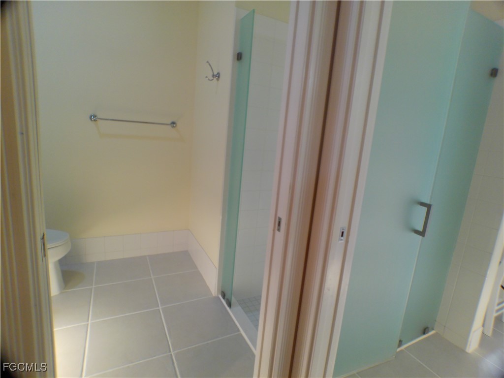 4780 Martinique Way Naples, FL 34119 - Photo 28 of 49 a bathroom with a glass door shower