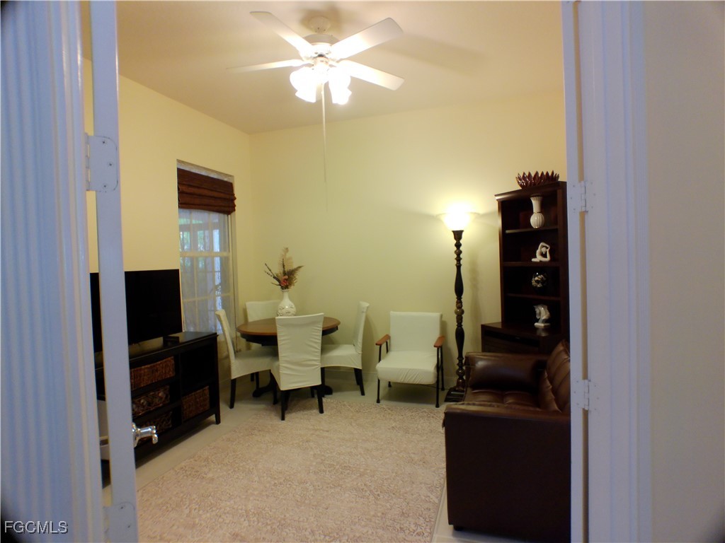 4780 Martinique Way Naples, FL 34119 - Photo 32 of 49 a living room with furniture and a flat screen tv