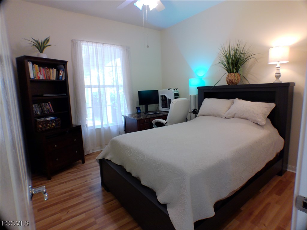 4780 Martinique Way Naples, FL 34119 - Photo 33 of 49 a bedroom with a bed and a potted plant