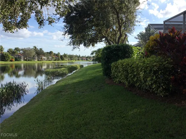 a view of a patio with a table chairs and a small yard