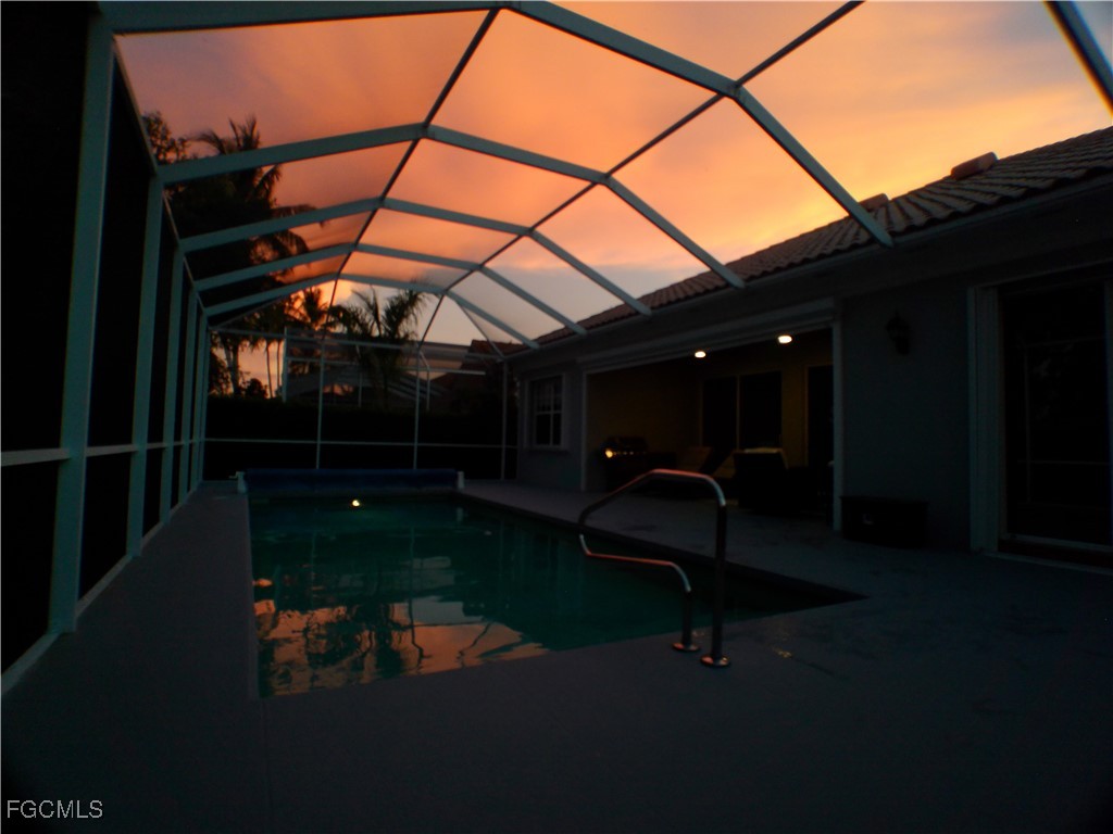 4780 Martinique Way Naples, FL 34119 - Photo 6 of 49 a backyard of a house with table and chairs