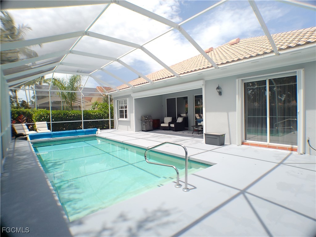 4780 Martinique Way Naples, FL 34119 - Photo 8 of 49 a view of a house with a porch and a backyard