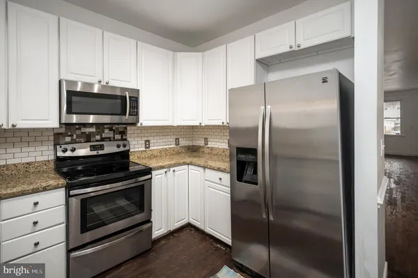 a kitchen with a refrigerator and a sink
