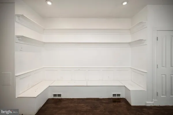 a view of a hallway with wooden floor and a window
