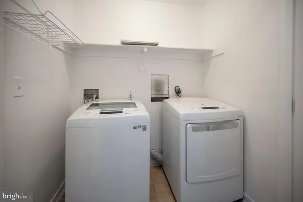an empty room with a window and a ceiling fan