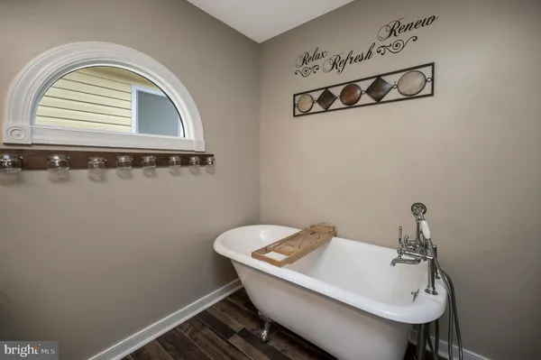 a bathroom with a granite countertop toilet sink and mirror