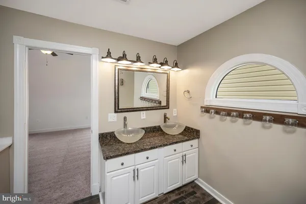 an empty room with windows & cabinet