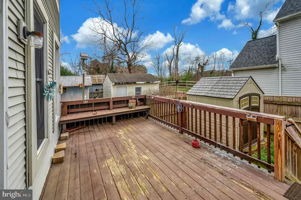 a view of swimming pool with outdoor seating and trees in the background