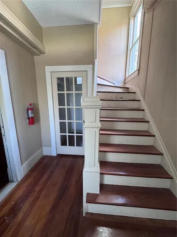 a view of entryway with wooden floor and stairs