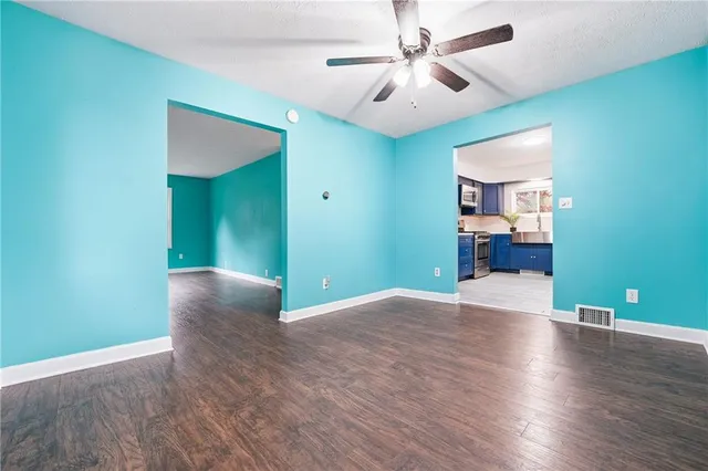 a view of a kitchen with wooden floor and a ceiling fan