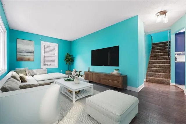 a living room with furniture and a flat screen tv