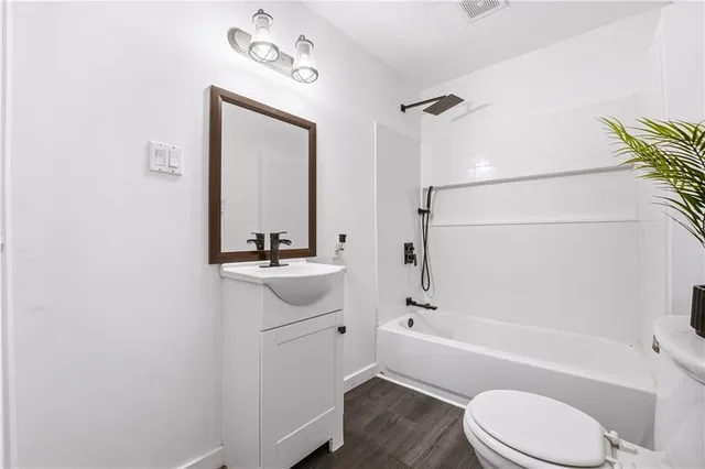 a bathroom with a sink a toilet and bathtub