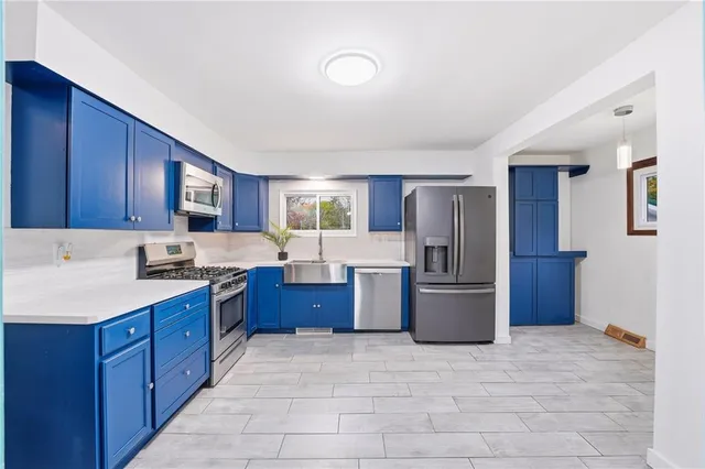 a kitchen with stainless steel appliances granite countertop a stove refrigerator and cabinets