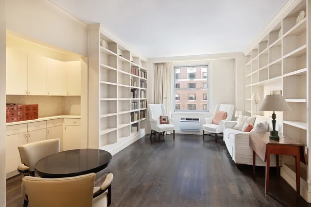 a kitchen with white cabinets and sink