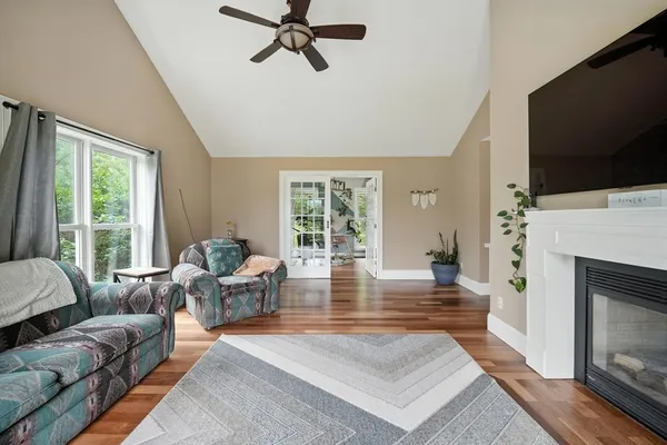 a living room with furniture a flat screen tv and a fireplace