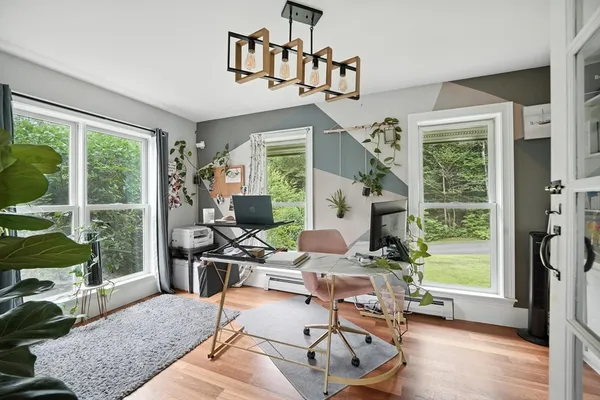 a living room with furniture tv and a large window