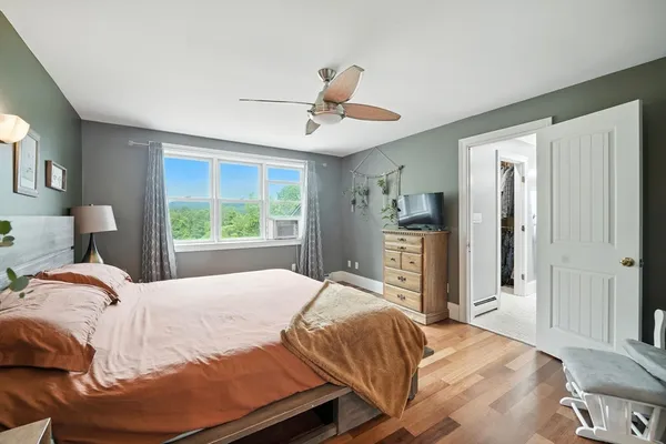 a bedroom with a large bed and a window
