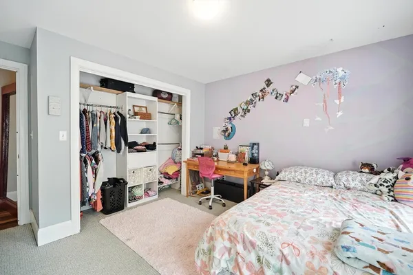 a bedroom with bed and a window