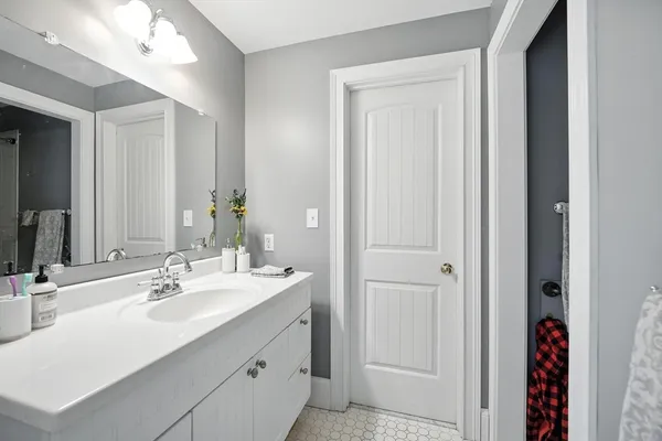 a bathroom with a sink vanity and a mirror