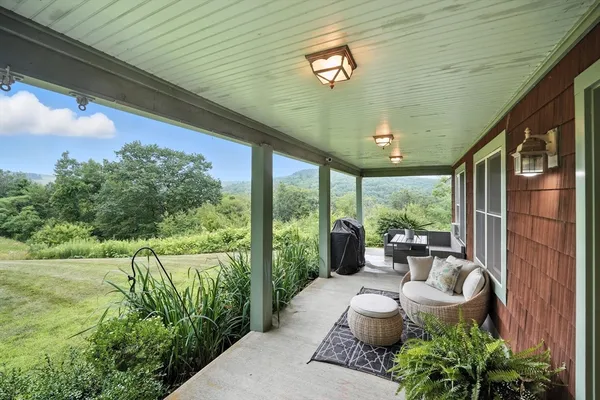 a view of a house with a yard and sitting area