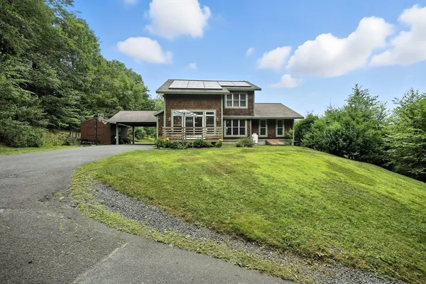 an aerial view of a house with a yard