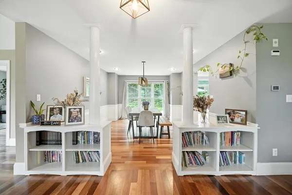 a living room with furniture and a book shelf