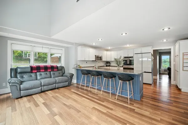 a living room with furniture and kitchen view