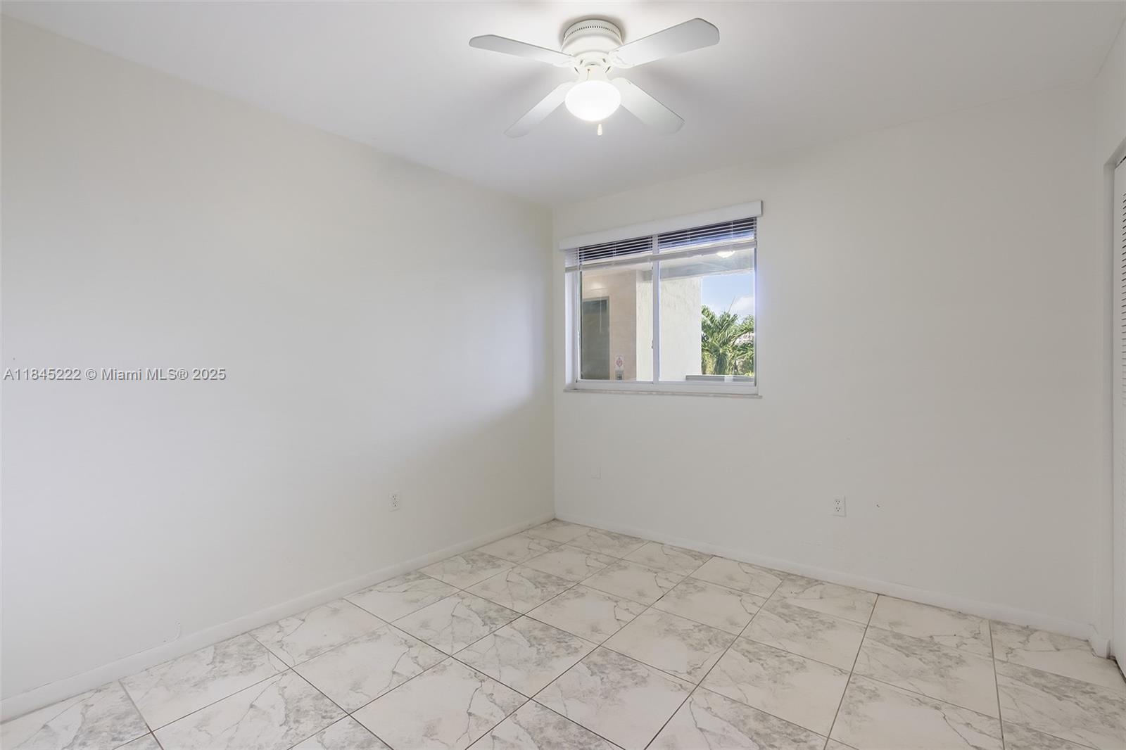 1060 Northwest 7th Street, Unit 101 Miami, FL 33136 - Photo 11 of 20 wooden floor in an empty room with a window