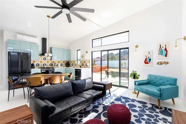 a living room with furniture a rug and a chandelier