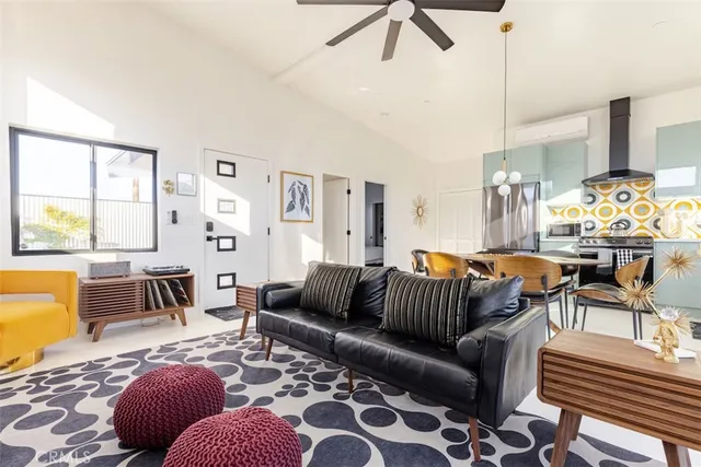 a living room with furniture ceiling fan and a rug