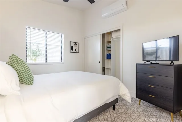 a bedroom with a bed and a window