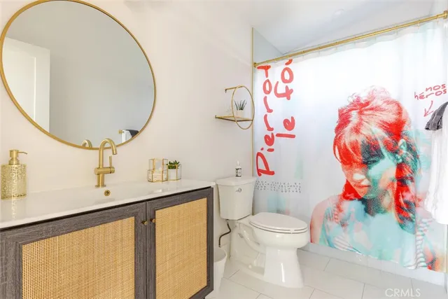 a bathroom with a sink toilet and a mirror