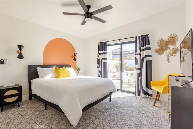 a bedroom with a bed a table and chair