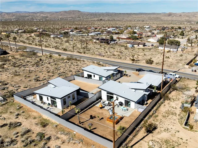 an aerial view of a residential building with swimming pool