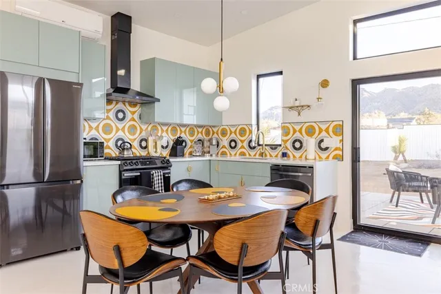 a view of a dining room with furniture and a chandelier