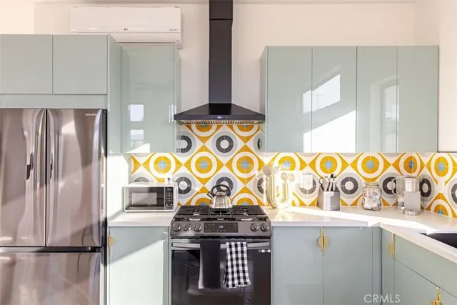 a kitchen with stainless steel appliances granite countertop a refrigerator and a stove