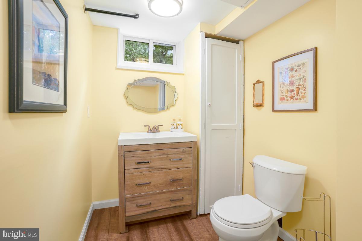 6013 Hawthorne Street Cheverly, MD 20785 - Photo 23 of 30 a bathroom with a toilet a sink a mirror and a shower