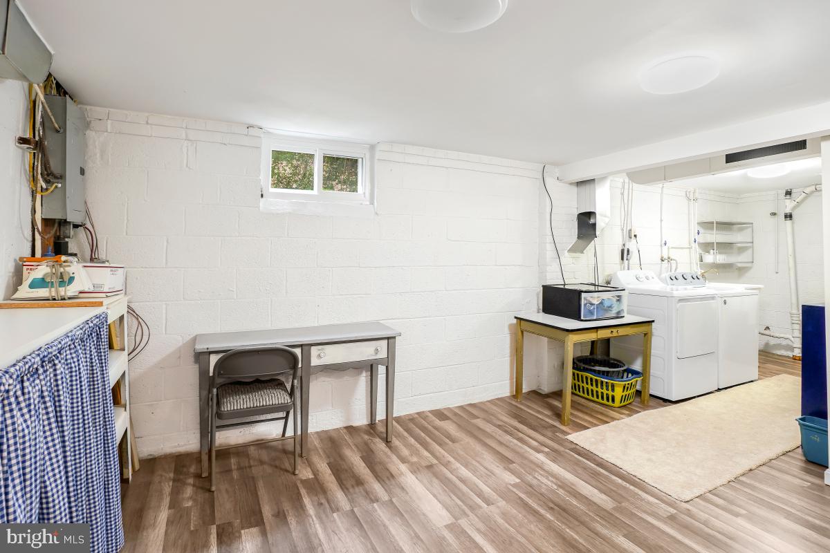 6013 Hawthorne Street Cheverly, MD 20785 - Photo 24 of 30 a bedroom with a bed and a table in it