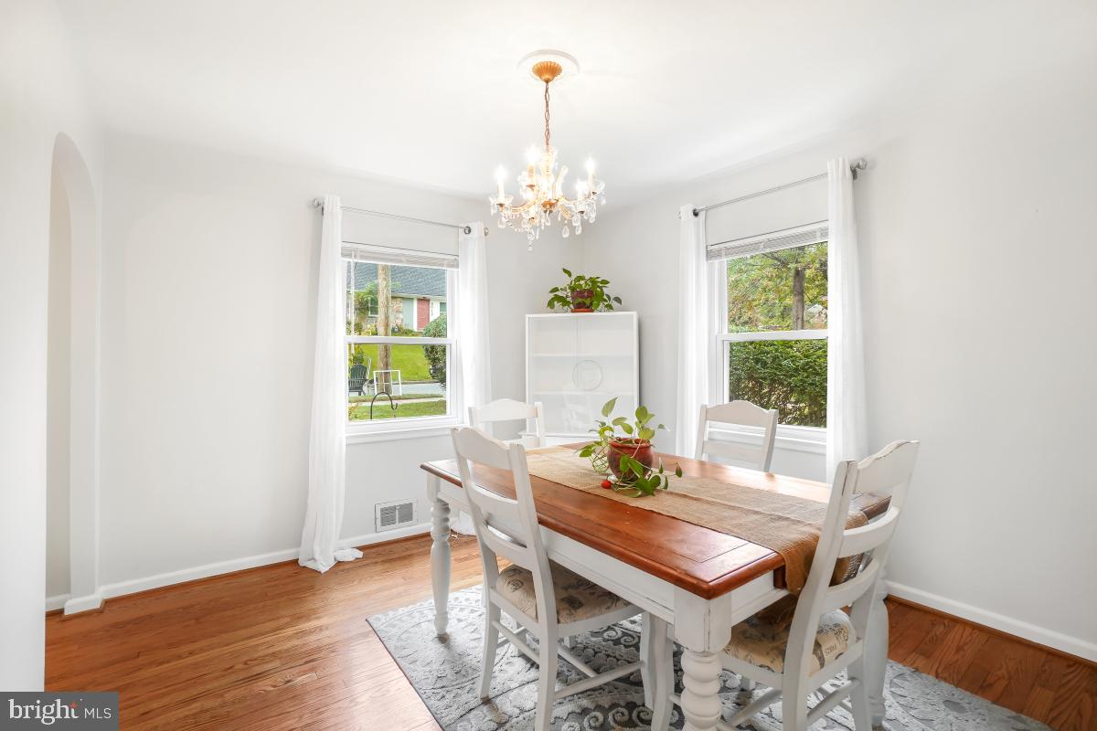 6013 Hawthorne Street Cheverly, MD 20785 - Photo 10 of 30 a dining room with furniture a chandelier and wooden floor
