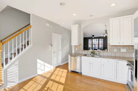 a kitchen with stainless steel appliances a stove a sink and a refrigerator