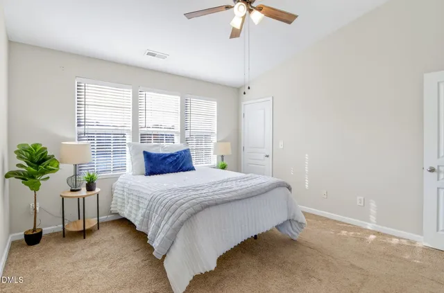 a bedroom with a bed and window