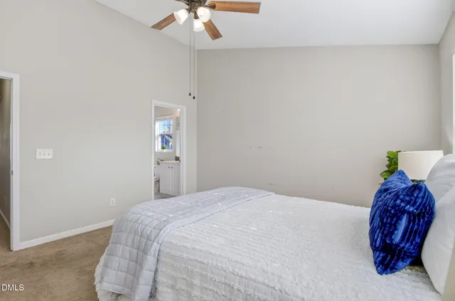 a bedroom with a bed and a potted plant
