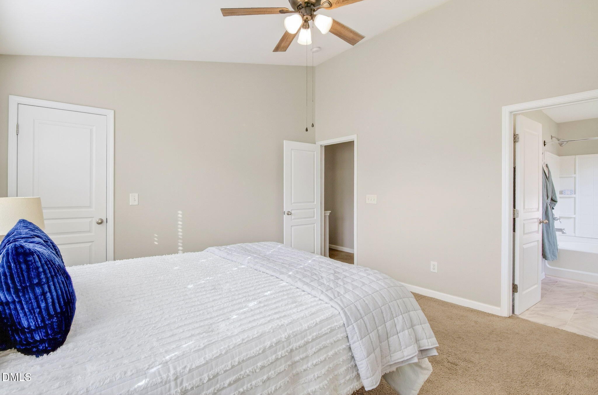 603 Cupola Drive Raleigh, NC 27603 - Photo 23 of 32 a bedroom with a large bed and a chandelier