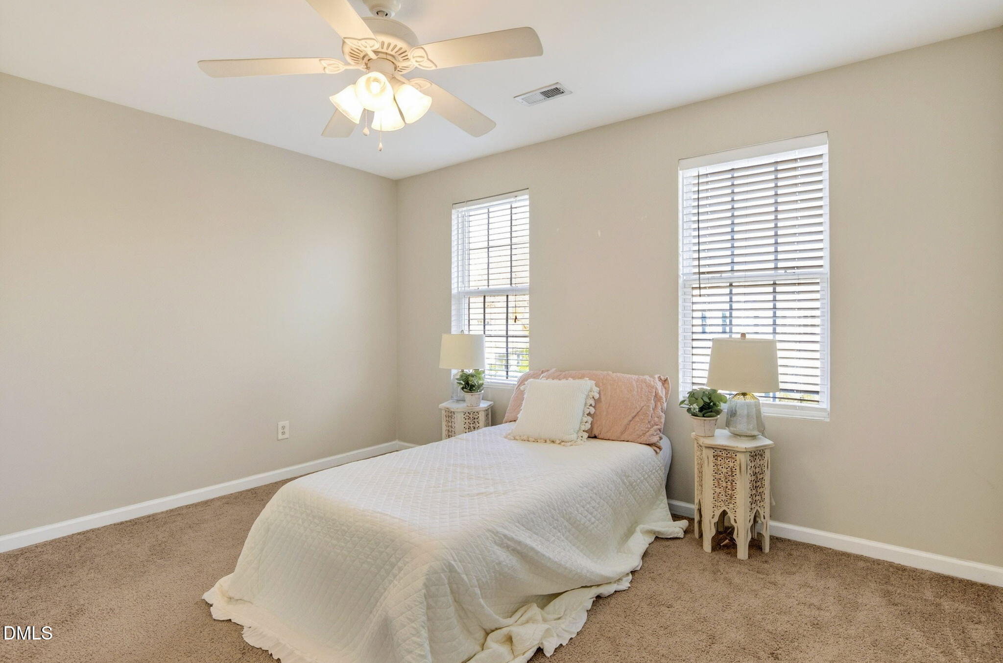 603 Cupola Drive Raleigh, NC 27603 - Photo 27 of 32 a bedroom with a bed and a chandelier