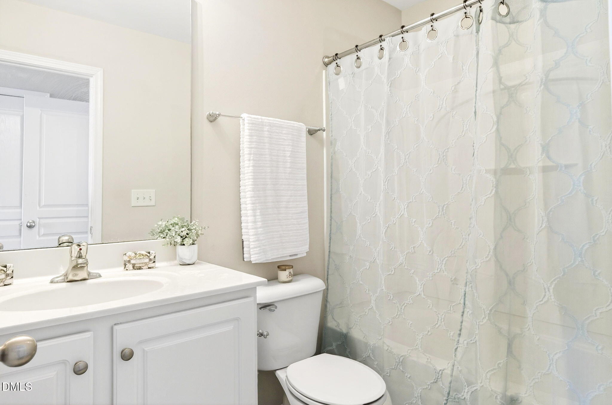 603 Cupola Drive Raleigh, NC 27603 - Photo 28 of 32 a bathroom with a sink a toilet and shower curtain