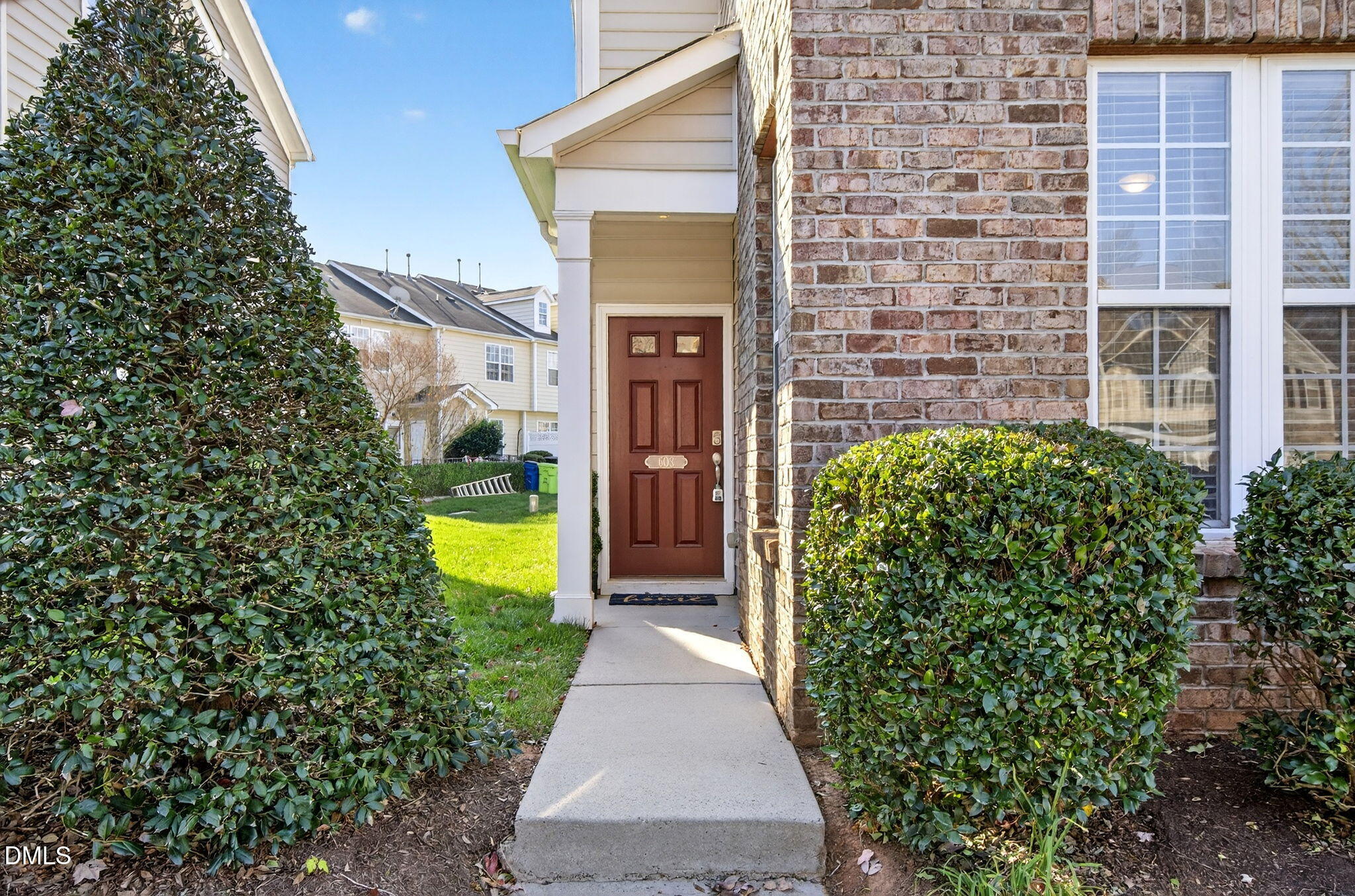 603 Cupola Drive Raleigh, NC 27603 - Photo 3 of 32 a view of a pathway that has brick walls and a potted plant