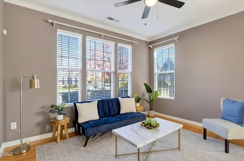 a living room with furniture fireplace and a window