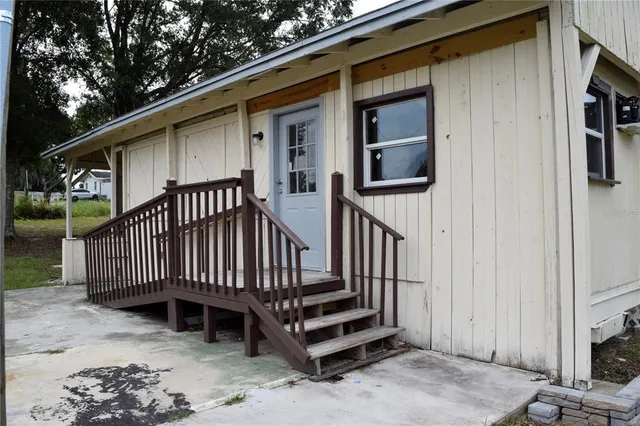 a view of a house with wooden floor roof and wooden fence